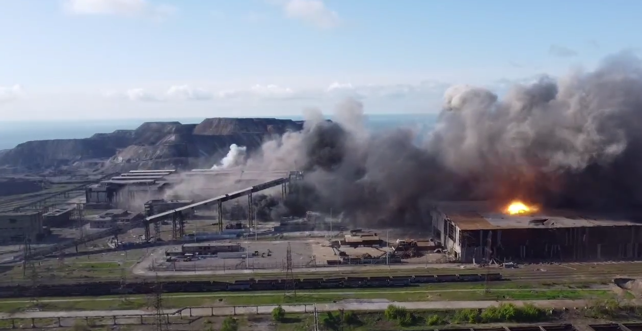 Smoke and flames rising from an industrial complex.