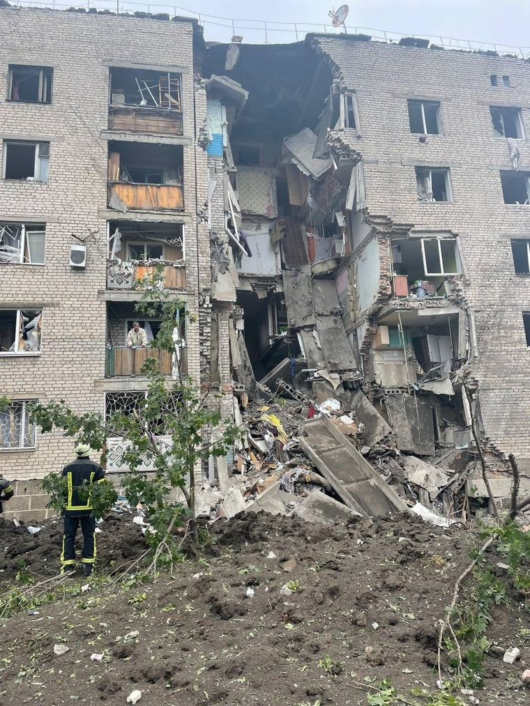 A five-storey apartment building with a collapsed central section.